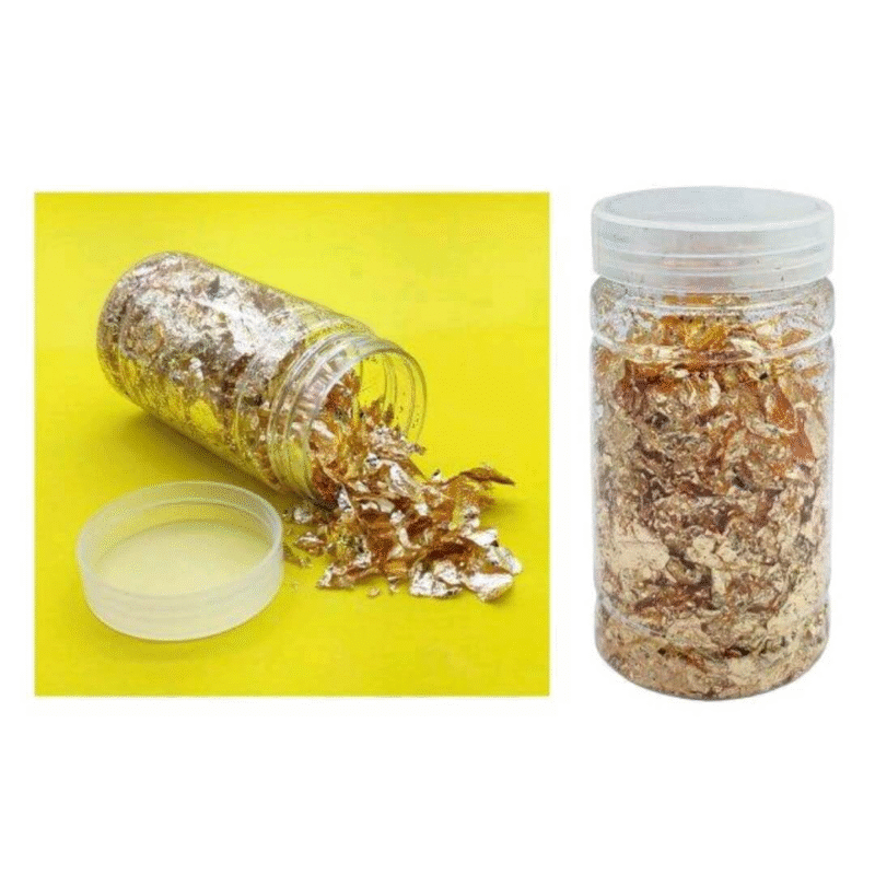 Open jar of golden gliding flakes spilling out on a bright yellow background