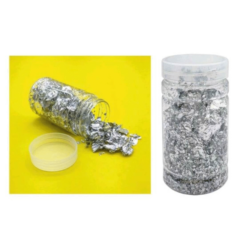 Silver gilding flakes in a clear jar, perfect for resin art, craft embellishment, and metallic finishes on various surfaces.