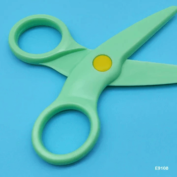 Green safety scissors for kids with rounded tips and ergonomic design.